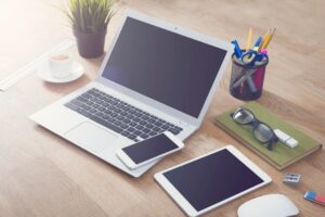 laptop, cell phone, and tablet on table